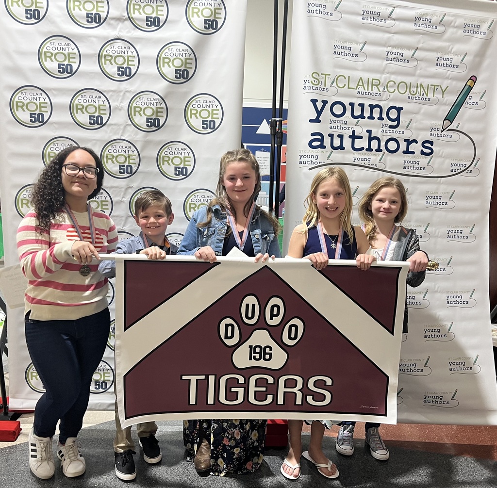 Four students hold Dupo Tiger Banner for Young Authors 
